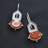 92.5 silver dangler earrings with rust coloureds stone.